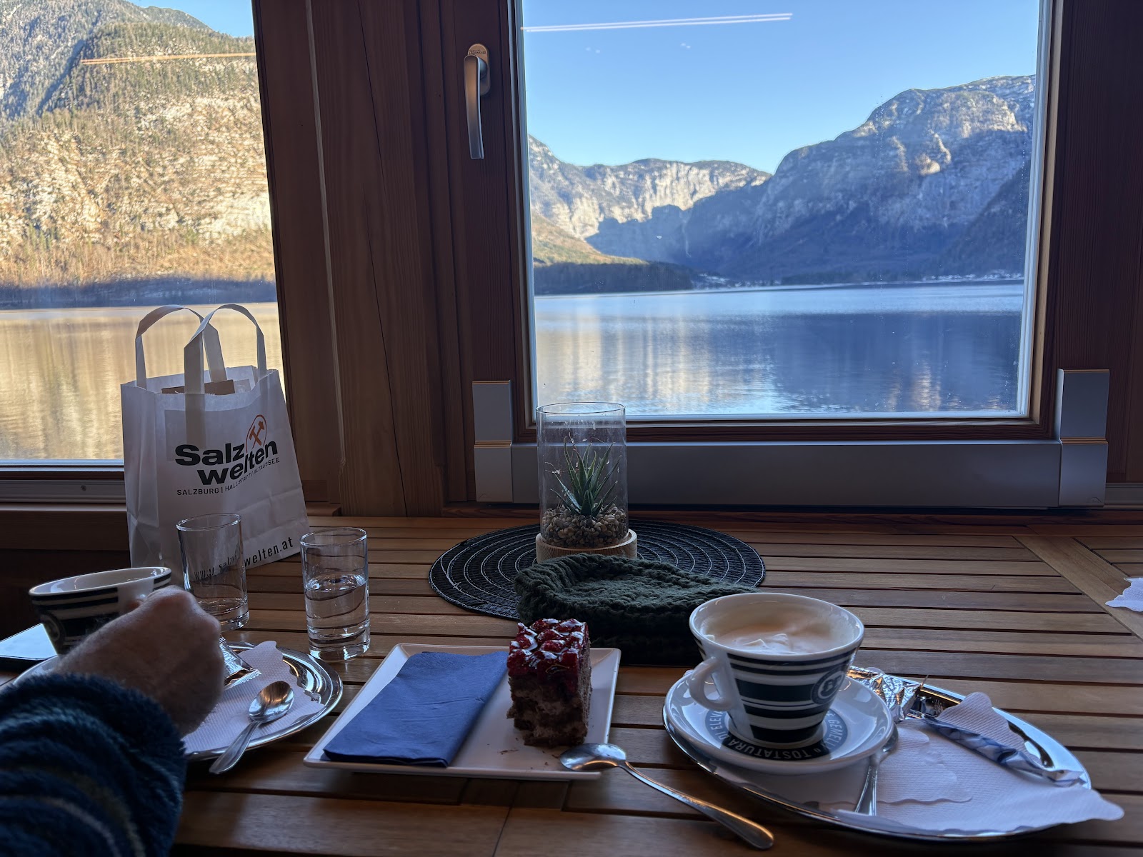 Coffee and pastry beside a lake-view window